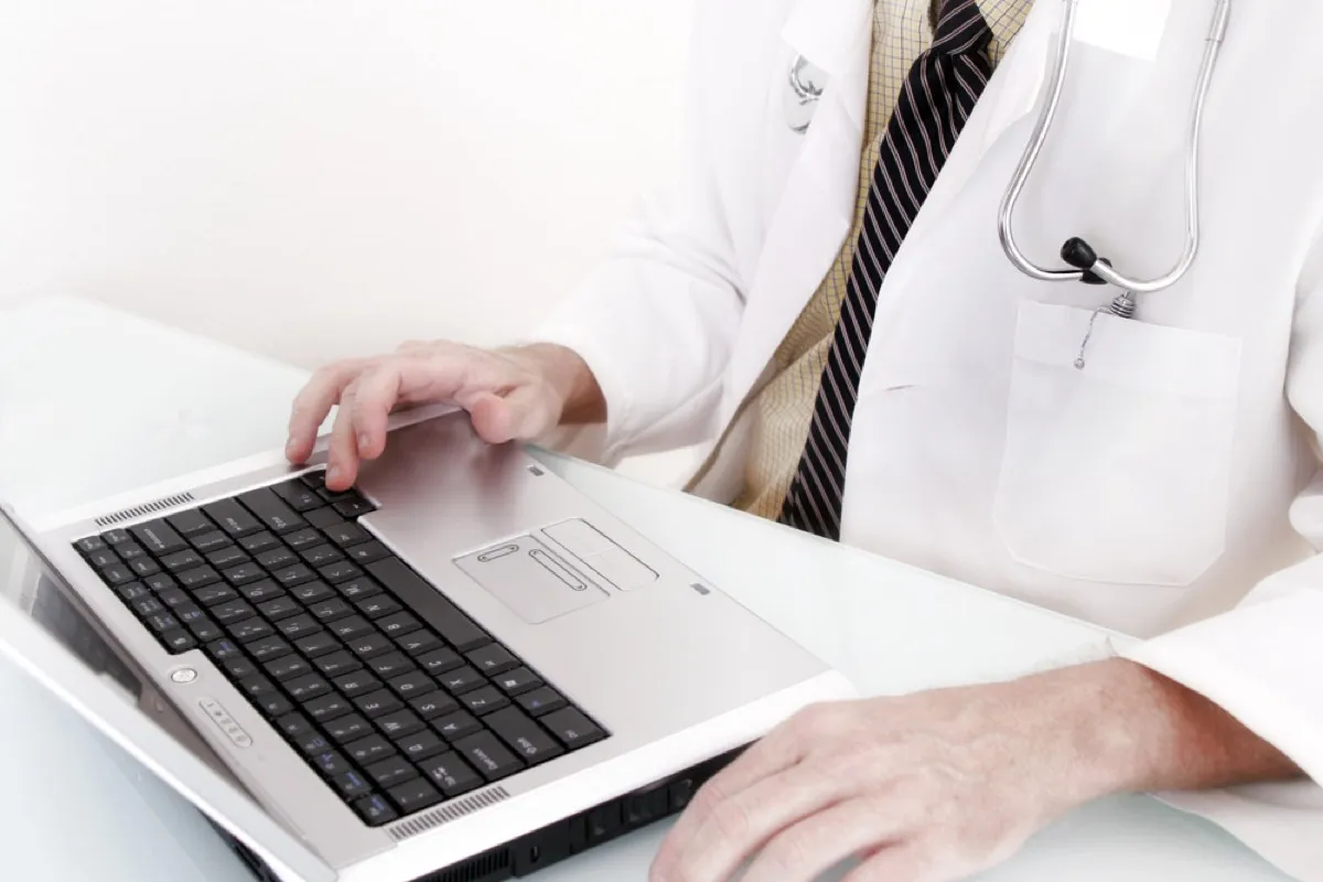A doctor using the laptop