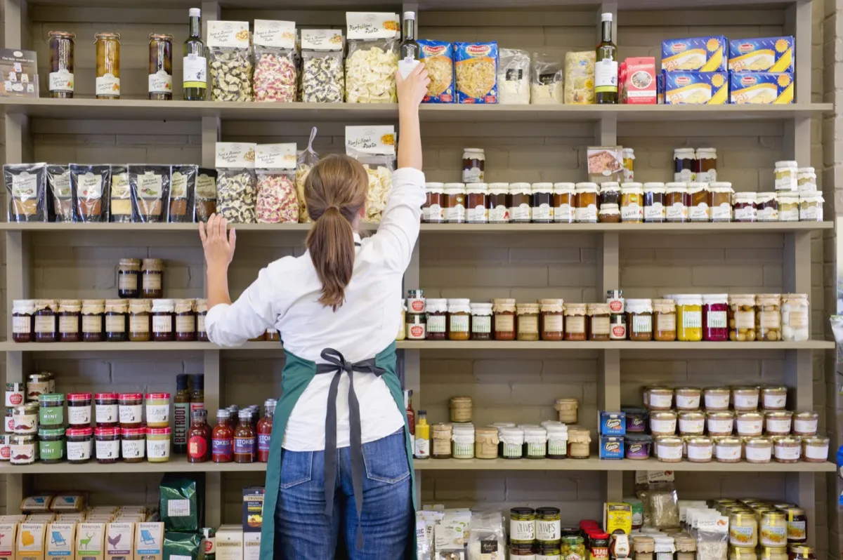 a staff reorganizing the product shelf