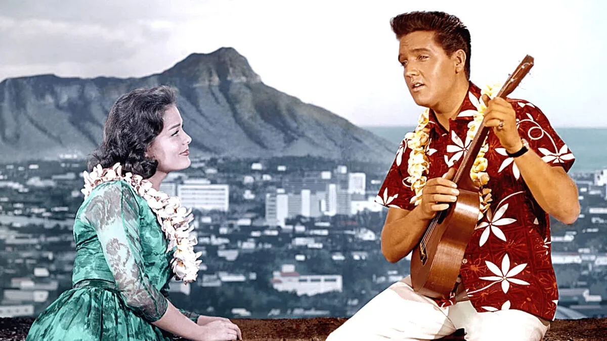 Elvis Presley singing in a Hawaiian shirt